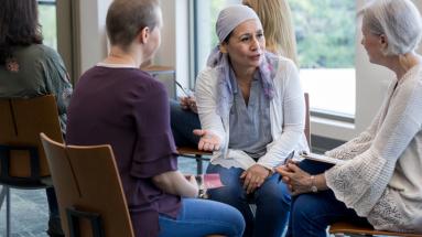 Three women sitting in a circle talking 