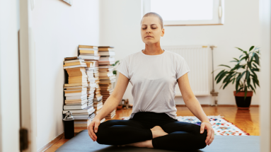 Woman on yoga mat criss cross apple sauce 