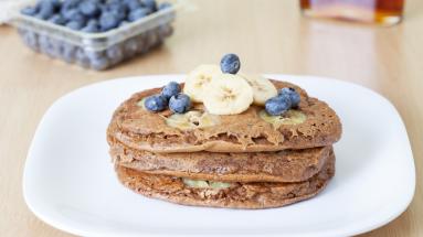 Pancakes topped with banana and blueberries 