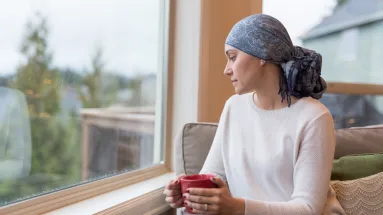 Woman sitting on chair and looking out of the window