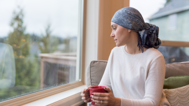 Woman sitting on chair and looking out of the window 