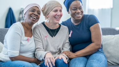 group of women on couch smiling 