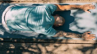 Man doing downward dog yoga pose 