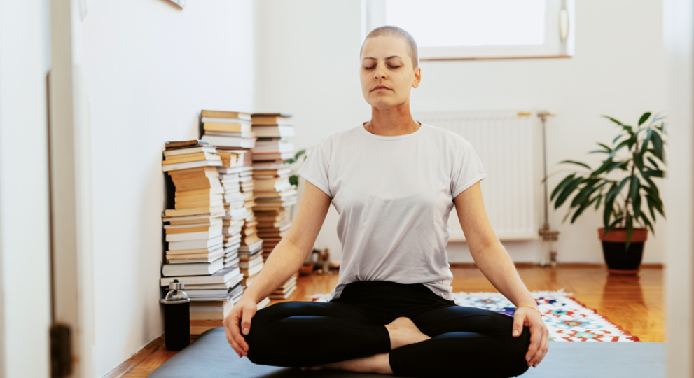 Woman on yoga mat criss cross apple sauce
