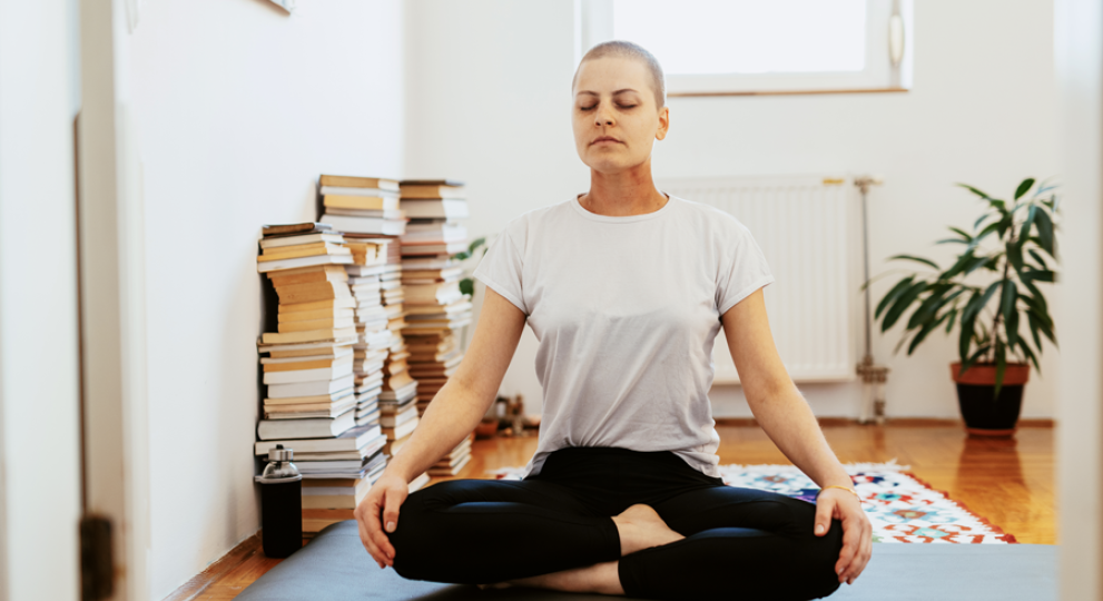 Woman on yoga mat criss cross apple sauce 