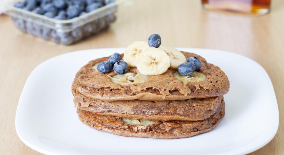 Pancakes topped with banana and blueberries 