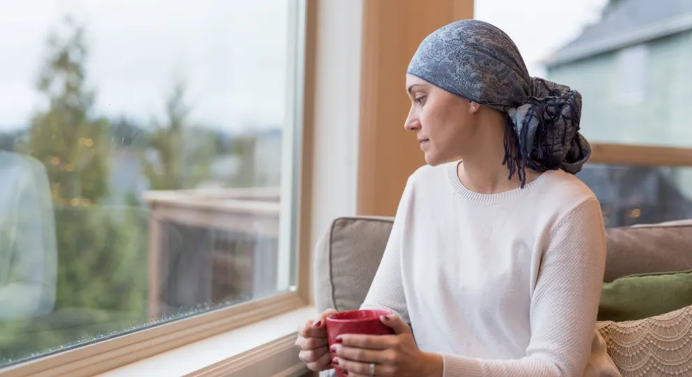 Woman sitting on chair and looking out of the window