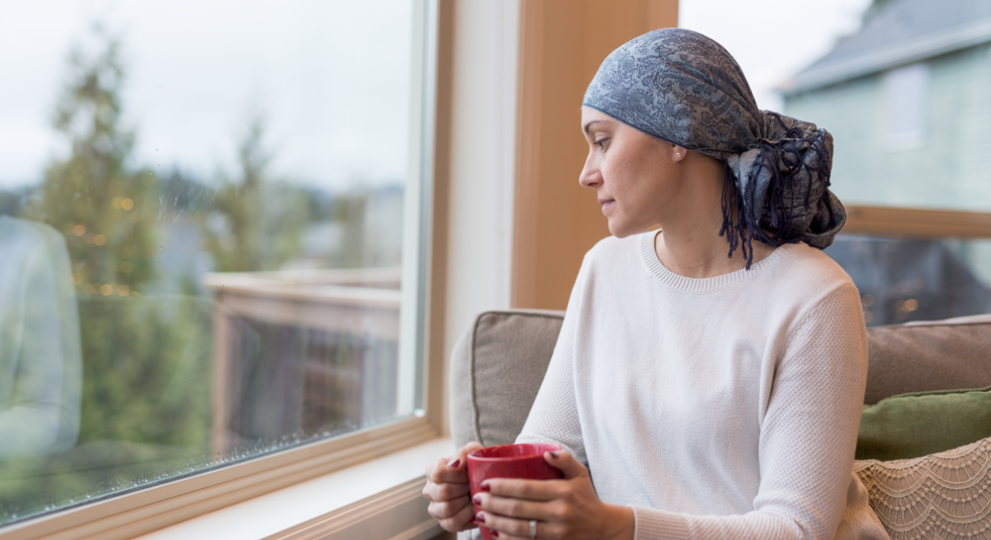 Woman sitting on chair and looking out of the window 