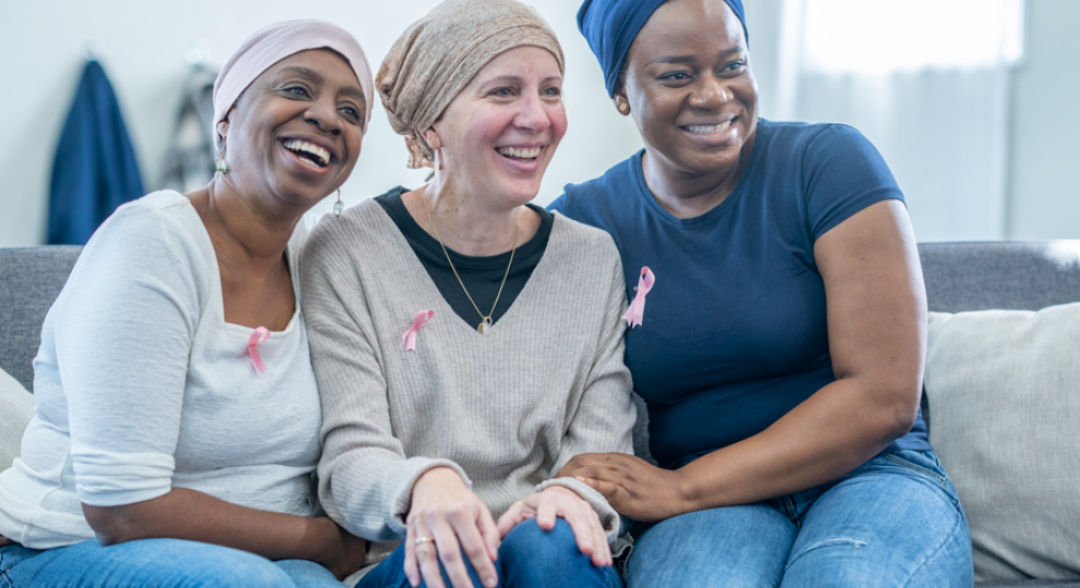 group of women on couch smiling 