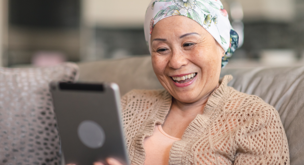 Woman on ipad while sitting on couch 