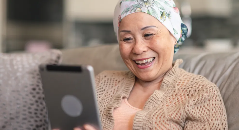 Woman on ipad while sitting on couch