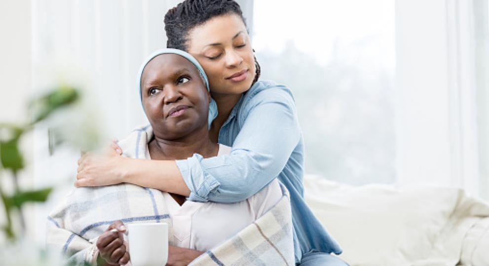 A woman hugging a female relative 